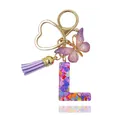 Portachiavi lettera L in resina viola con farfalla, nappa e anello a cuore - Lettera L (Stile 11)