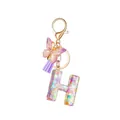 Resin letter H keychain with sparkling colorful star sequins, purple butterfly and tassel - Letter H