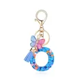 Porte-clés lettre O en résine avec paillettes, pompon et pendentif papillon bleu - Lettre O-Thème Paillettes Bleues (QS2157)