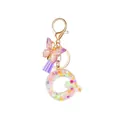 Resin letter Q keychain with purple tassel, glitter butterfly and gold star sequins - Style 17