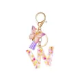 Resin letter W keychain with pressed flowers, purple tassel and butterfly charm - Style 21