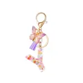 Resin letter Y keychain with colorful flowers, purple butterfly, and tassel - Style 23