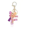 Porte-clés lettre F en résine avec fleurs roses, pompon violet et pendentif papillon - Lettre F-Thème Floral Violet Orange (QS2157)