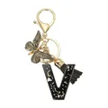 Porte-clés lettre V en résine avec paillettes, pompon noir et pendentif papillon doré - Lettre V (Style 22)