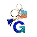 Porte-clés lettre G en résine avec paillettes bleues/vertes, fermoir doré et gland bleu - Lettre G Paillettes Dégradé Bleu-Vert (QS2157)