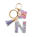 Porte-clés lettre N en résine avec paillettes cœur, pompon lilas et papillon doré - Lettre N Paillettes Cœur Gland Mauve (QS2157)