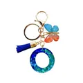 Porte-clés lettre O en résine avec paillettes bleu-vert, papillon et pompon bleu - Lettre O Paillettes Bleu-Vert (QS2157)