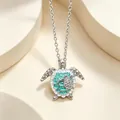 Silver mother and child sea turtle necklace with green enamel on light beige background - Silver Sea Turtle