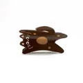 Detail of cute brown acetate cat hair claw clip showing glossy finish and spotted pattern - Brown