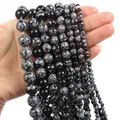Detailed macro view of natural snowflake obsidian round beads with unique grey mineral patterns - Snowflake Obsidian