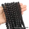 Close-up of matte black porous lava stone round beads held in hand for DIY jewelry - Lava Stone