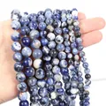 Macro shot of polished blue sodalite natural stone beads with white marble textures - Blue Sodalite