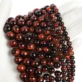 Polished red tiger eye gemstone beads with natural chatoyant effect and striped texture - Red Tiger Eye