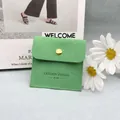 Light green suede jewelry pouch with gold snap button and fashion jewelry logo - Green