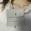 Light gray microfiber jewelry envelope pouch with gold snap button and handmade logo - Silver Gray