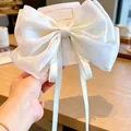 Elegant oversized pearl white fabric bow hair clip with long tassels on display card - Beige
