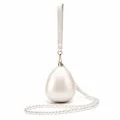 Detailed macro view of the egg-shaped clutch featuring a pearl sheen and gold metal clasp - Small Ball Pearl White
