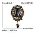Detalle de broche barroco vintage con gema negra y tallados de diamantes de imitación - Negro