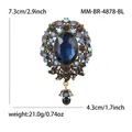 Broche barroco vintage con piedra azul ovalada y diseño floral detallado con cristal - Azul