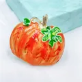 Macro detail of pumpkin brooch with orange enamel finish and green leaves for Halloween - Vintage Enamel Pumpkin Brooch
