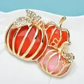 Elegant Halloween pumpkin brooch with sparkling rhinestones and golden metallic finish - Triple Pumpkin Design Brooch