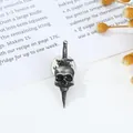 Macro detail of gothic skull and sword brooch with vintage silver and black enamel - Dagger Pierced Skull Brooch Style