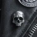 Retro punk skull rivet on black leather background with vintage silver finish - Hammered Texture Skull Style
