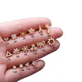 Orecchini a perno dorati in acciaio inossidabile con zirconi e design floreali - Oro