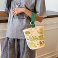 LUCKY canvas bucket bag in off-white and green featuring cute cartoon illustrations - Lucky Frog