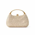 Vue macro d'une pochette de luxe dorée en strass avec poignée en métal et finition cristal - Abricot