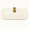 Close-up of artistic gold and silver organic metal clasp on cream PU clutch bag - Off White