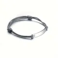 Macro detail of polished silver metal plate on adjustable grey braided rope bracelet - Grey Rope + Steel Color Plate