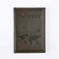 Close-up of textured dark faux leather passport cover with map design and white stitching - Olive Green