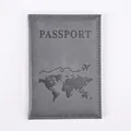 Close-up of grey PU leather passport cover with world map print and stitched edges - Gray