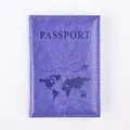 Macro detail of dark purple PU leather passport cover with world map and white stitching - Purple
