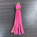 Hot pink PU leather tassel keychain with gold metal ring and cap on grey wood - Rose Red