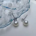 Macro detail of S925 sterling silver stamp on freshwater pearl earrings with zircon - Silver Needles White Gold Material