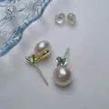 Macro shot of S925 silver pearl earrings with sparkling diamond studs and silicone backs - Silver Needles Made Of Gold Copper
