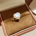 Detailed close-up of 18k gold plated heart ring with zircon stones in a jewelry box - One Size(Adjustable) / Gold White Zirconia