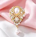 Close-up of vintage royal style brooch with rhinestones and pearl pendant details - Palace Vintage Drop Pearl Style / Gold