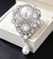 Detail of luxury baroque silver brooch with white pearls and sparkling rhinestones - Palace Vintage Drop Pearl Style / Silver