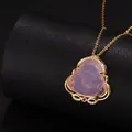 Pink jade Buddha necklace pendant in gold setting with pavé crystals on black stand - Purple