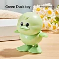 Wind-up green cartoon duck toy made of durable plastic for toddlers on wooden surface - Wind-up Jumping Duck (Green)