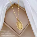 Macro shot of gold Virgin Mary oval pendant with micro-set zircons on a bamboo chain - Virgin Mary Oval Exquisite Carved Style(13)