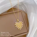 Close-up of gold heart pendant necklace with Virgin Mary relief and zircon stones - Virgin Mary Heart Surrounded by Zircon Style(22)