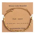 Gold Morse Code bracelet with beads and cylindrical bars on kraft paper card display - Gold (Fuck Cancer)