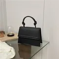 Minimalist black faux leather handbag with knotted handle and matte finish design - Black