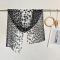 Lightweight leopard print silk scarf in black and white hanging on a minimalist rack - Leopard Black White