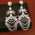 Detailed view of shimmering crystal fringe earrings on a luxury black jewelry box display. - Water Drop Tassel (HE32779) / Silver