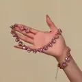 Close-up of pink crystal heart jewelry set held in hand - Pink